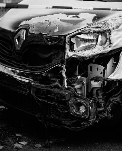 Claimant documenting car accident with photos and paperwork for insurance claim