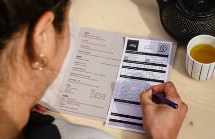 Person filling out consumer fraud class action claim form