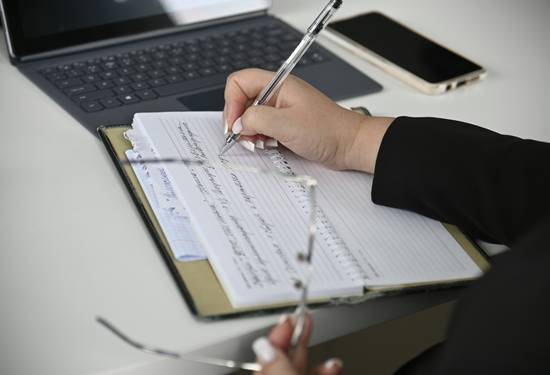 Person reviewing a consumer fraud class action notice and claim form