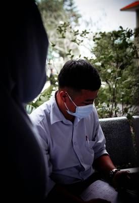 Doctor and injured employee reviewing accident report