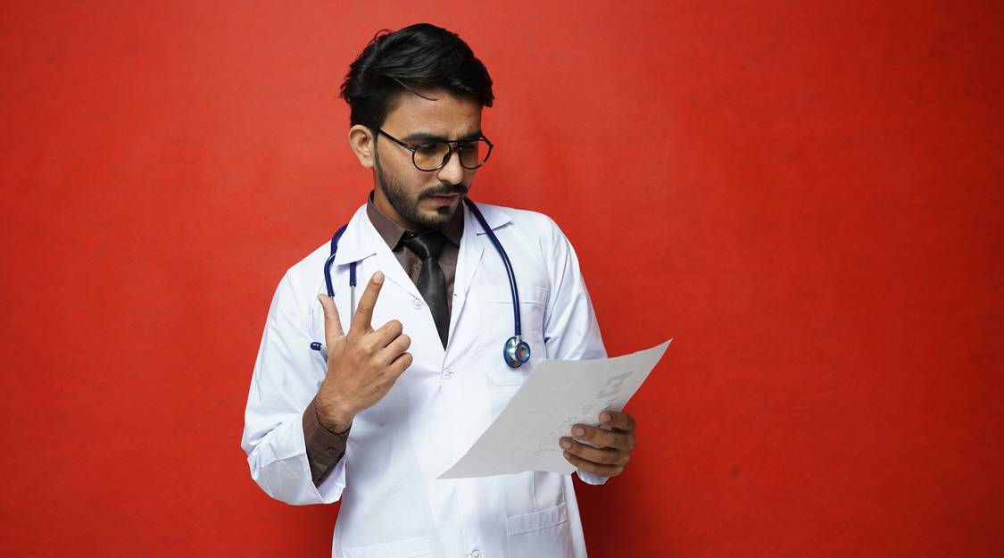 Doctor reviewing patient chart in hospital after possible misdiagnosis