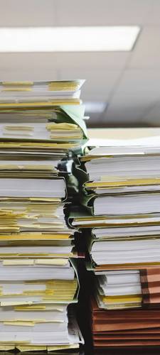 Stack of legal and medical documents for misdiagnosis settlement process