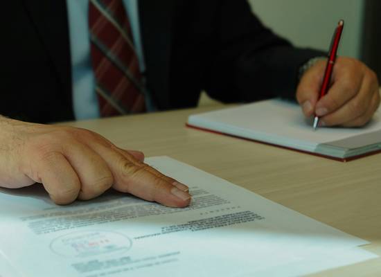 Attorney reviewing a defective product with recall paperwork visible on desk