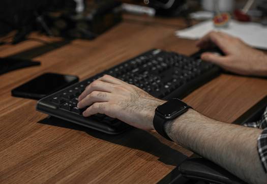 Office worker with wrist brace experiencing repetitive stress pain