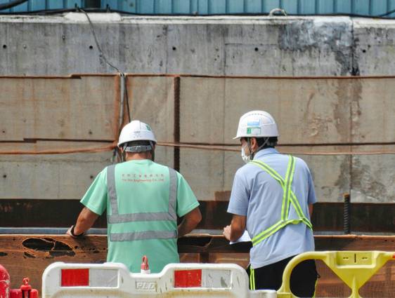Injured worker consulting with supervisor on a construction site