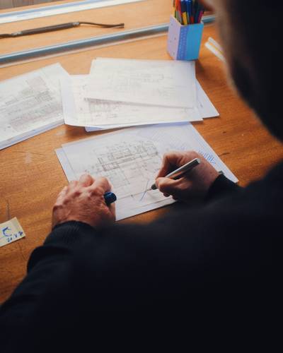 Attorney calculating wrongful death settlement value with legal documents and calculator